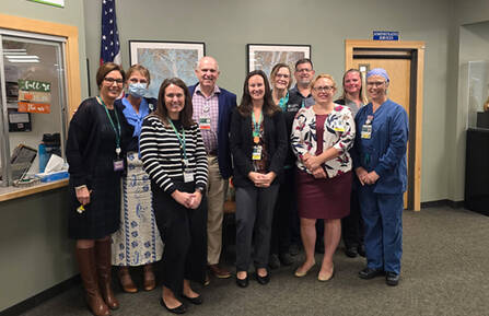 Group photo of October employee of the month Elizabeth Sheehan with coworkers