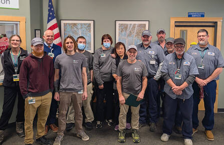 A group of Health Care Providers shown standing in a room