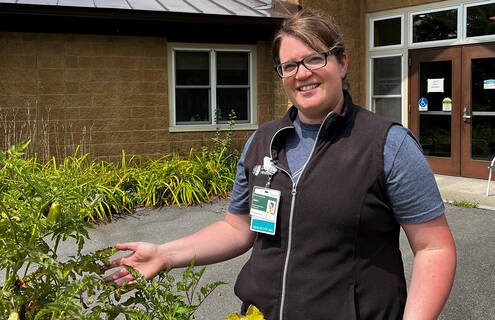 Jamie Landeen standing next to garden at Mt Ascutney Hospital and Health Center