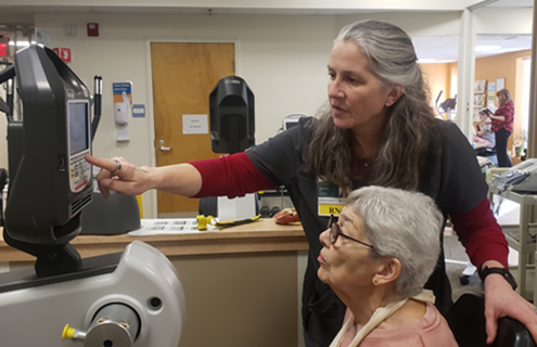 MAHHC’s Wendy Hubbard, RN, cardiac rehabilitation, assisting patient with exercise machine