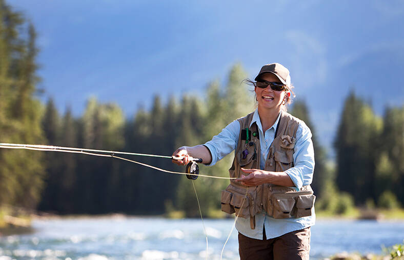 Woman fly fishing on a river